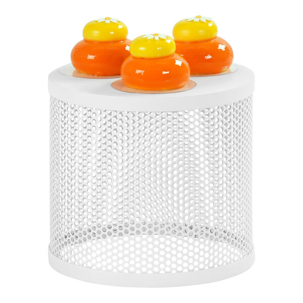A white Cal-Mil round metal display stand with orange and yellow round objects on top.
