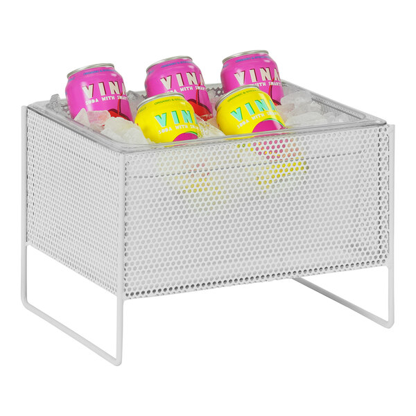 A Cal-Mil white metal ice housing with clear pan holding cans of soda on a table.