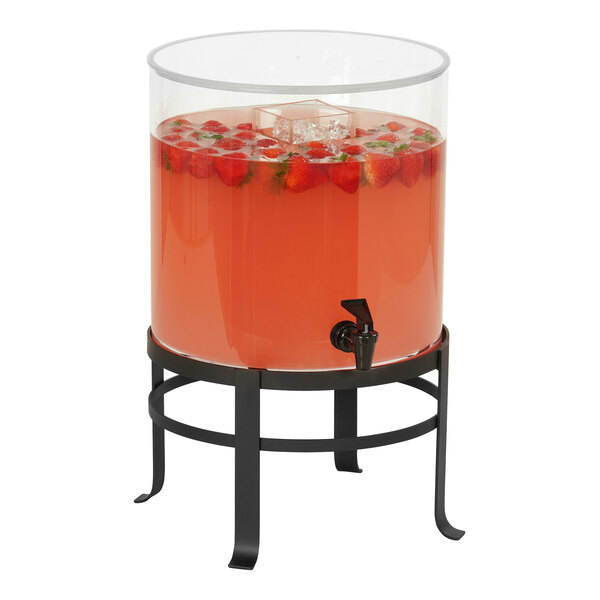 A Cal-Mil glass beverage dispenser with a black metal base on a table.
