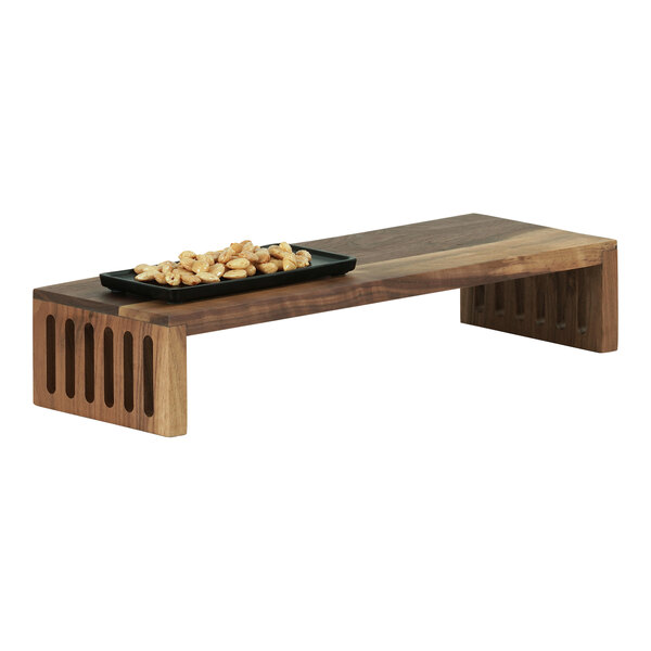 A Cal-Mil walnut rectangular display stand with food on it.