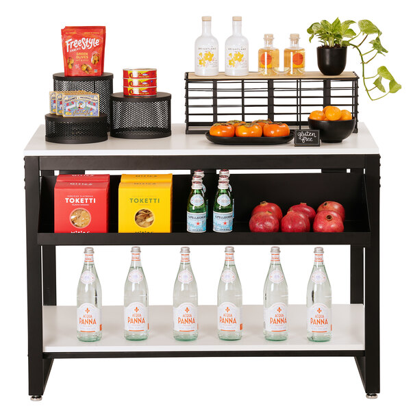 A white Cal-Mil nesting merchandising table with food and drinks on it.
