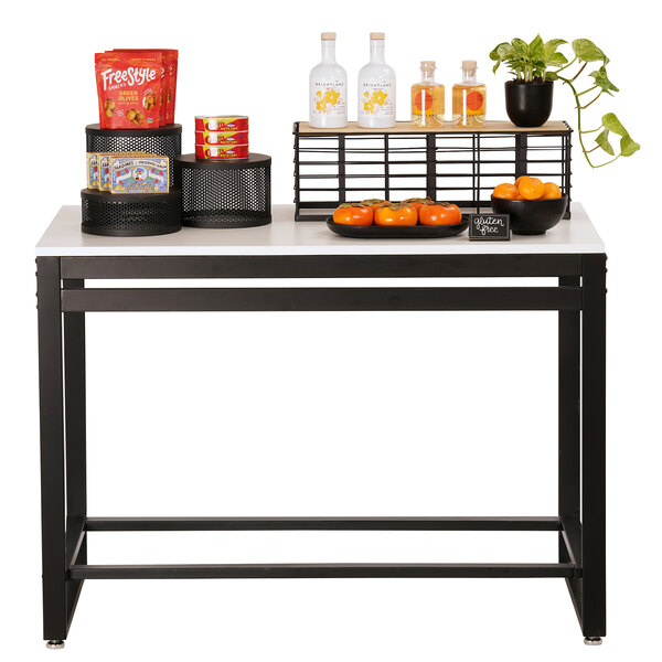 A white Cal-Mil nesting table with a variety of food items on it.