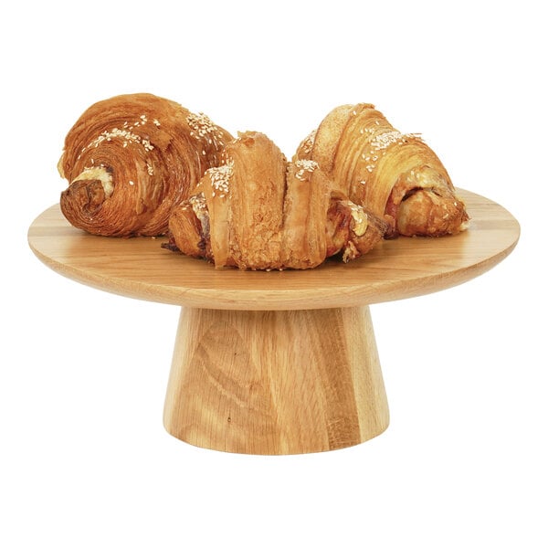 A croissant on a Cal-Mil round oak cake stand.