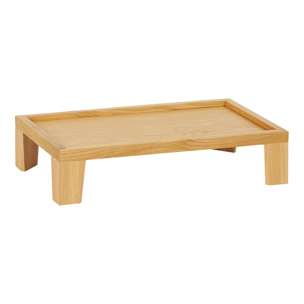 A Cal-Mil oak display stand with tapered legs holding a wooden tray on a table.