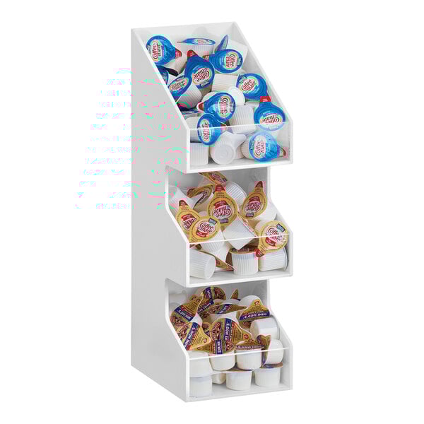 A white shelf with several compartments with clear bin fronts.