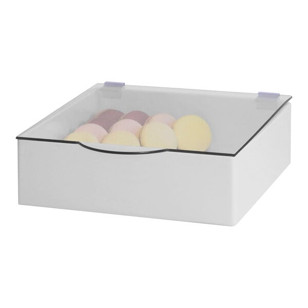 A white box with a clear lid holding round bowl lids.