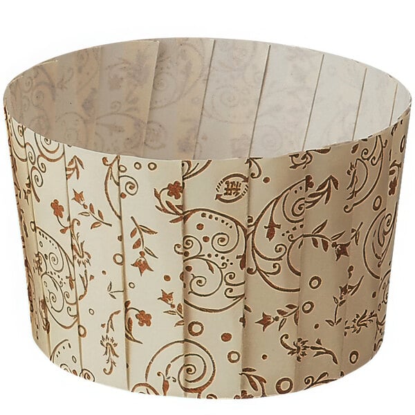 A Welcome Home Brands brown paper baking cup with a blossom pattern.