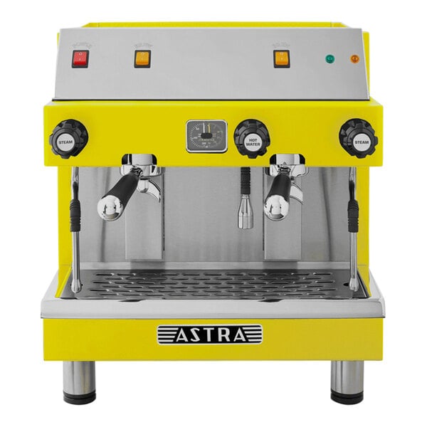 A yellow and silver Astra Mega II compact espresso machine with two coffee cups.