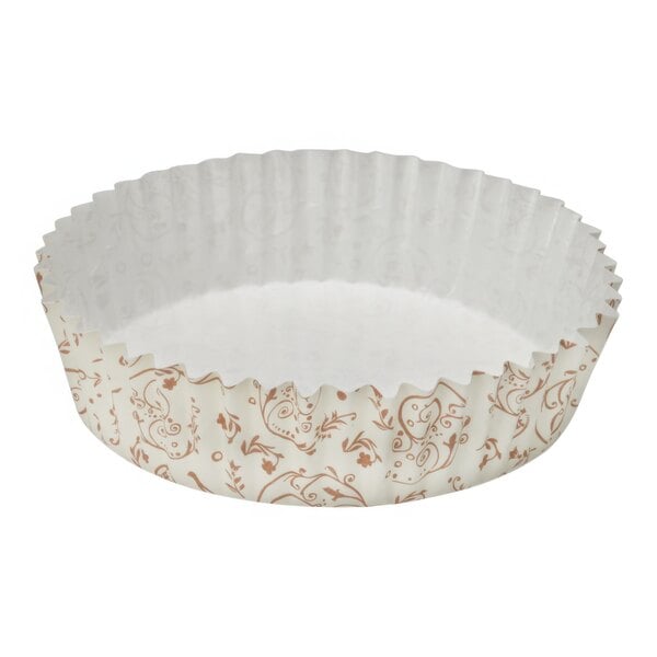 A brown paper baking cup with a white and brown blossom pattern.