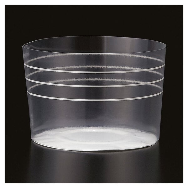 A clear plastic baking cup with white stripes.