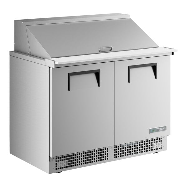 A True stainless steel 2 door mega top refrigerator on a counter.