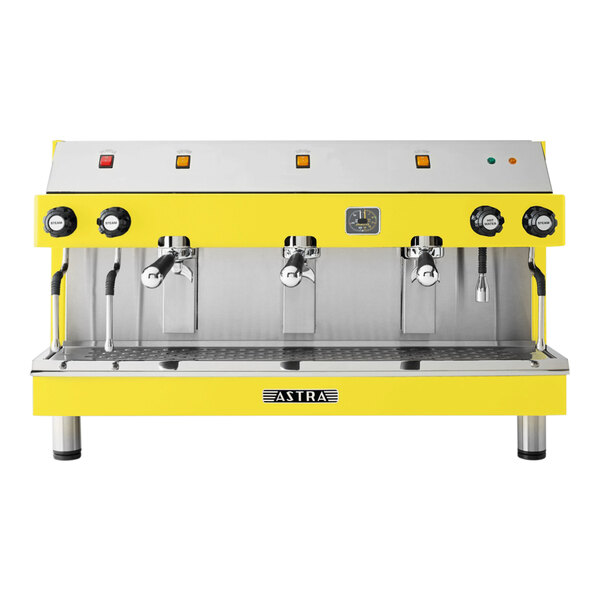 A yellow and silver Astra Mega III semi-automatic espresso machine with three spouts.