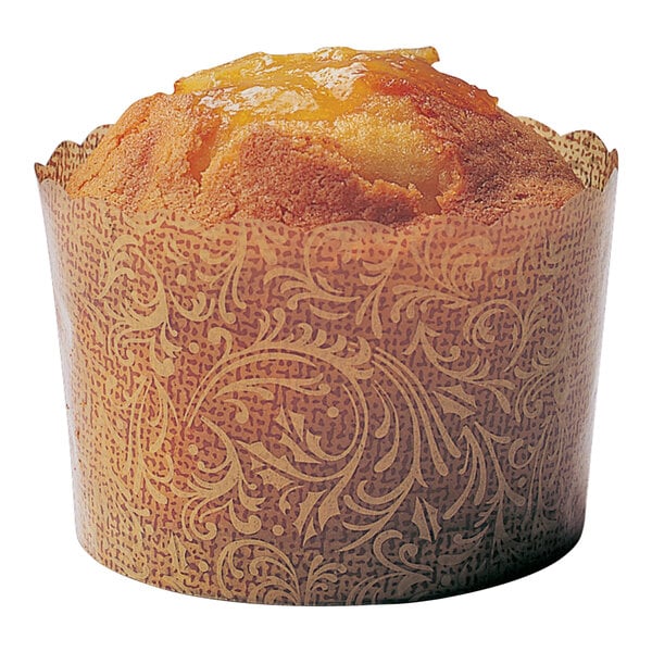 A muffin in a Welcome Home Brands brown antique swirls scalloped paper baking cup.