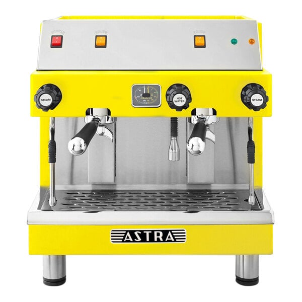 A yellow and silver Astra Mega II semi-automatic espresso machine with two coffee cups.