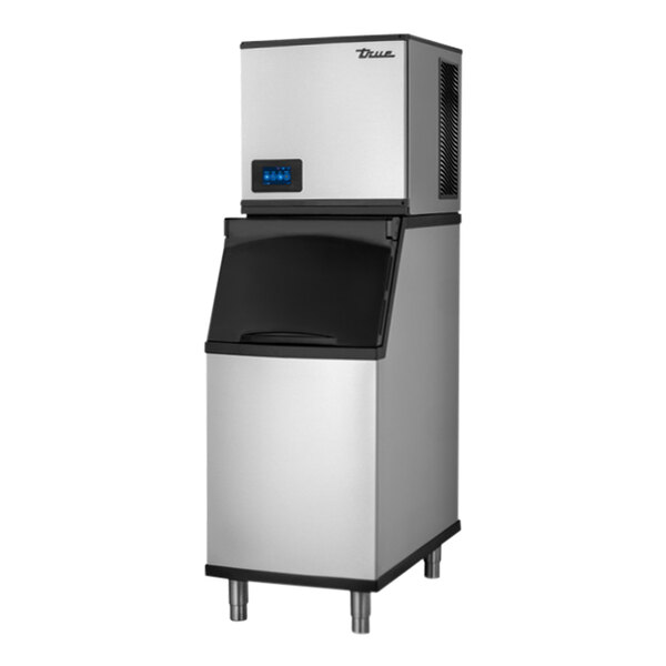 A silver and black rectangular True Ice air cooled ice machine with a black rectangular aluminum bin.