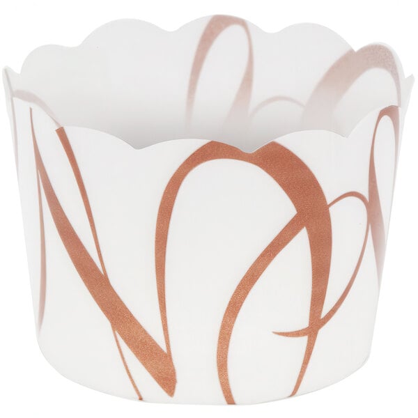 A white Welcome Home Brands plastic baking cup with a brown swirled pattern.