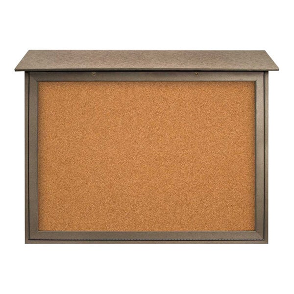 A cork board with a metal frame and a weathered wood bottom.