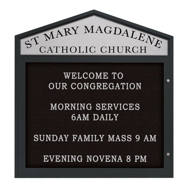 A black United Visual Products enclosed letterboard with white letters that reads "St. Mary Magdalene Catholic Church" with a pointed header.