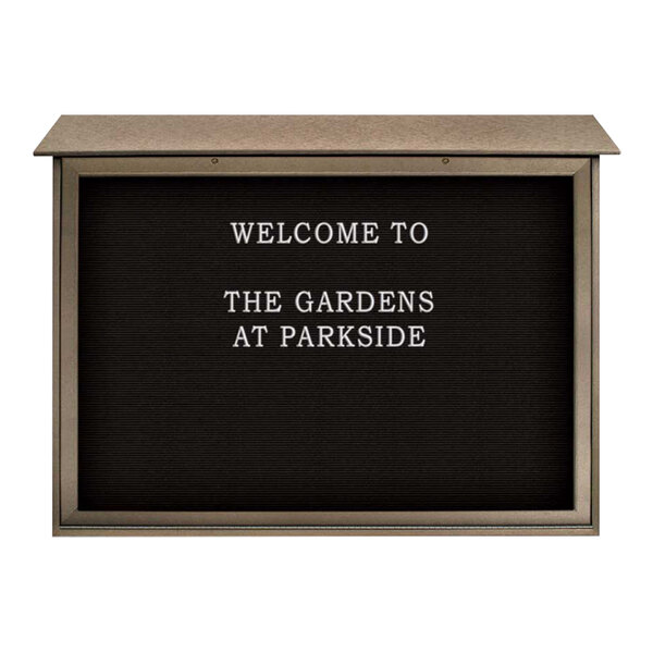 A black and weathered wood United Visual Products message center with white text on a sign.