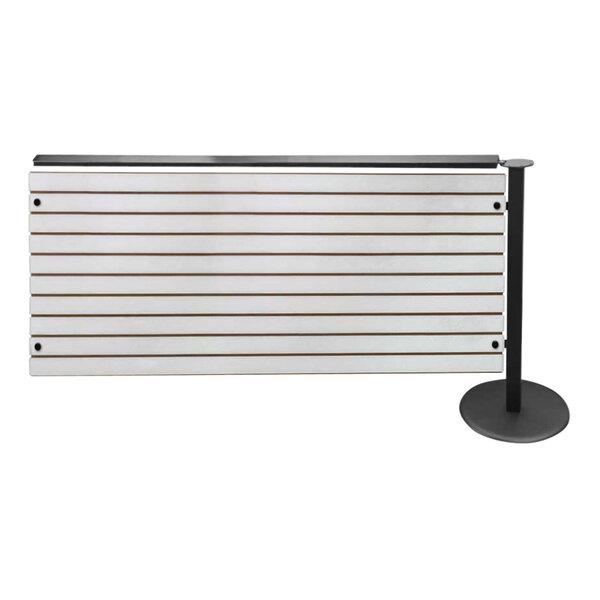 A white and black metal bar with slatwall dividers and a sign.