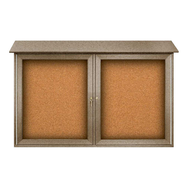 A brown double door message center with a corkboard inside a weathered wood frame.