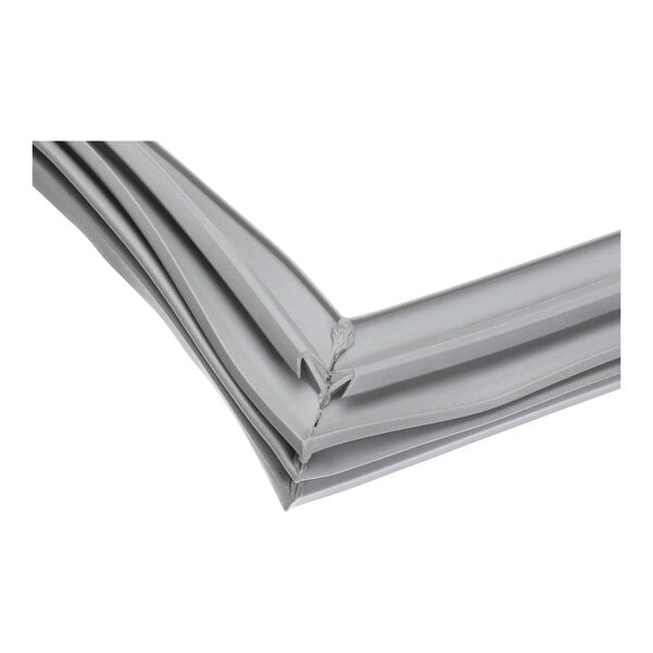 A close-up of a stack of grey plastic strips with a white object in the background.