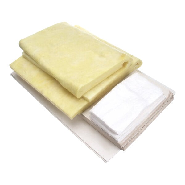 A stack of yellow and white insulation sheets for a Frymaster fryer.