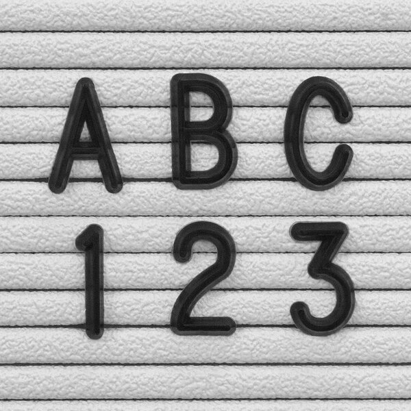 A black Helvetica character set with the letters "abcs 123" on a white background.