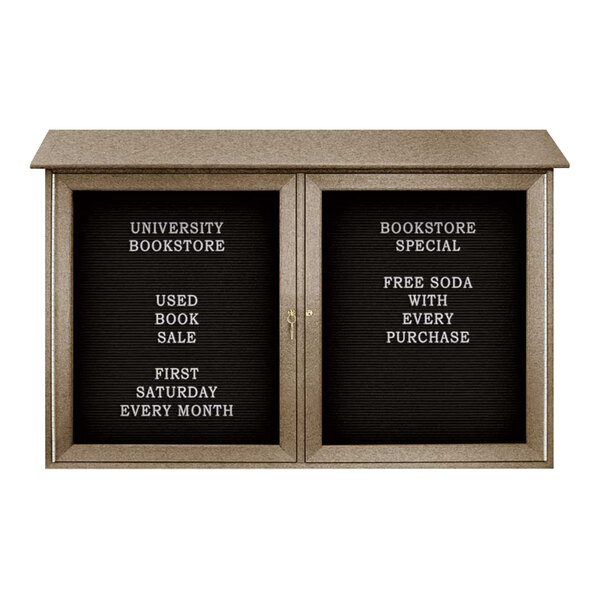 A black United Visual Products double door message center with a white letter board and white text.