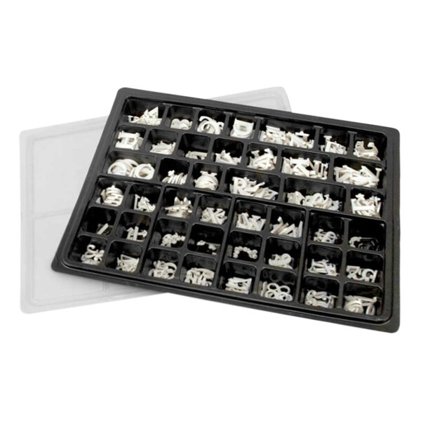 A tray of white United Visual Products Roman characters and numbers.