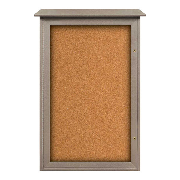 A cork board with a weathered wood frame and a glass door.