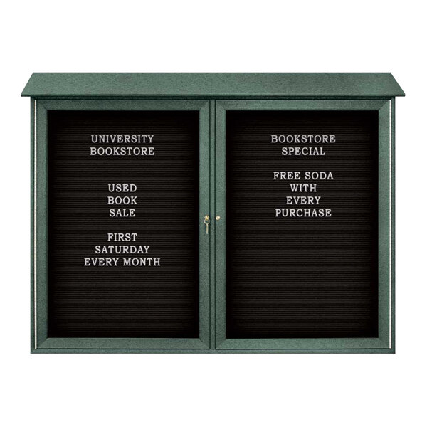 A woodland green double door bulletin board with black felt lettering on white plastic.