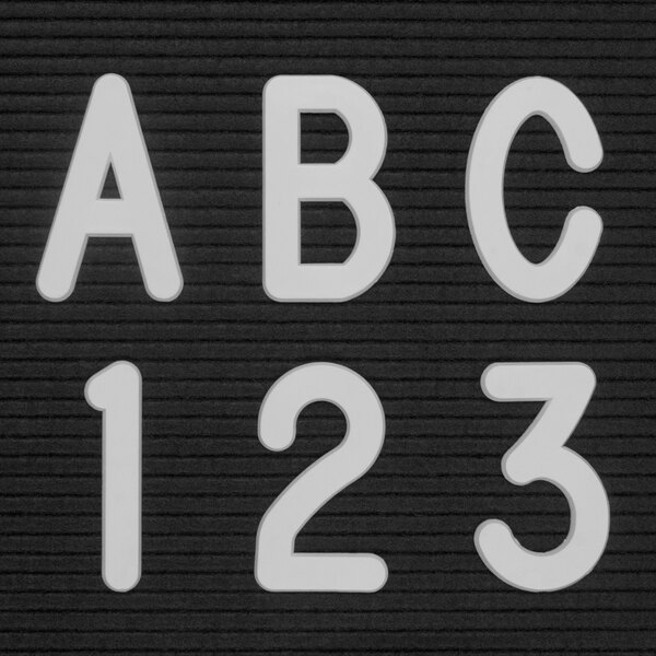 A group of white United Visual Products Helvetica letters and numbers on a black background.