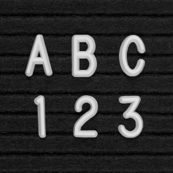 A close up of white United Visual Products Helvetica letters that say abc 123.