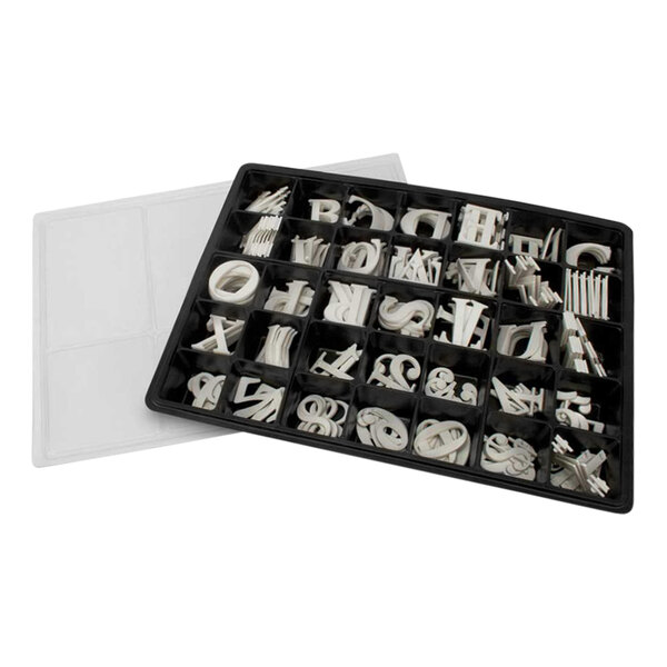 A white tray holding United Visual Products Roman character letters and numbers.