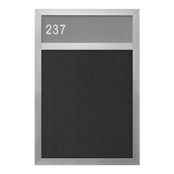 A close-up of a United Visual Products hall identification board with a black and silver satin frame and black felt with a number on it.