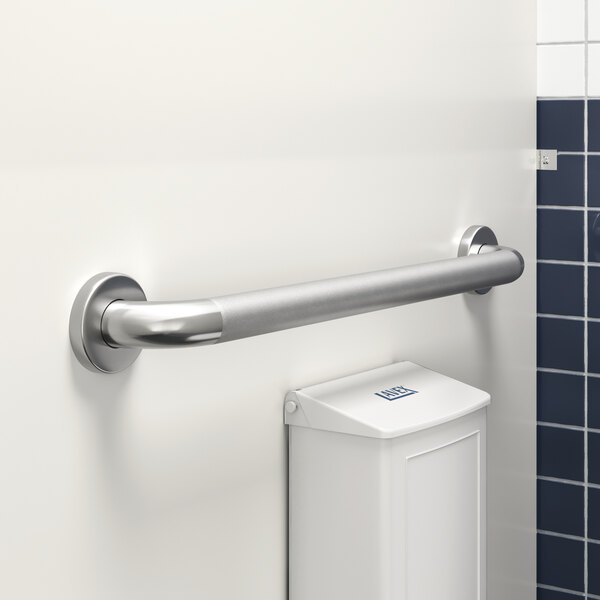 A Lavex 24" restroom grab bar with a peened grip on a wall next to a toilet.