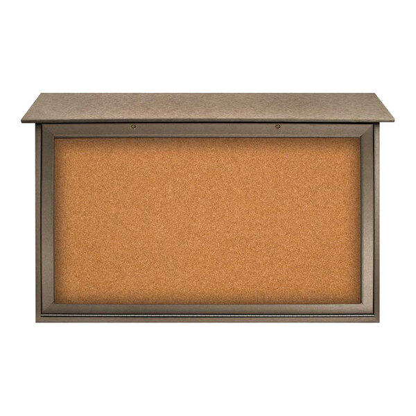 A corkboard with a weathered wood frame on the bottom and metal frame on top.