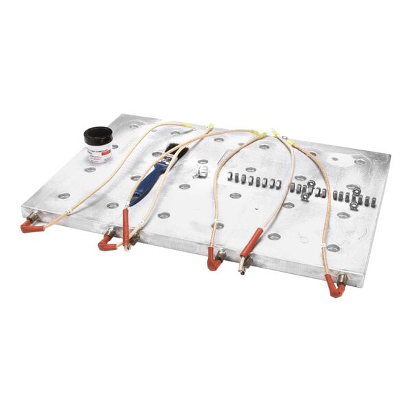 An Accutemp cast heater replacement kit metal plate with wires and tools.