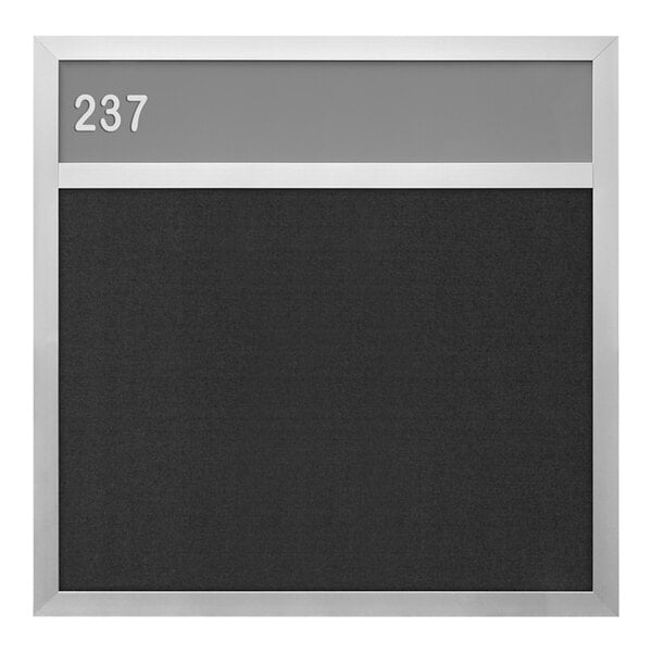 A black board with a silver frame and white numbers.