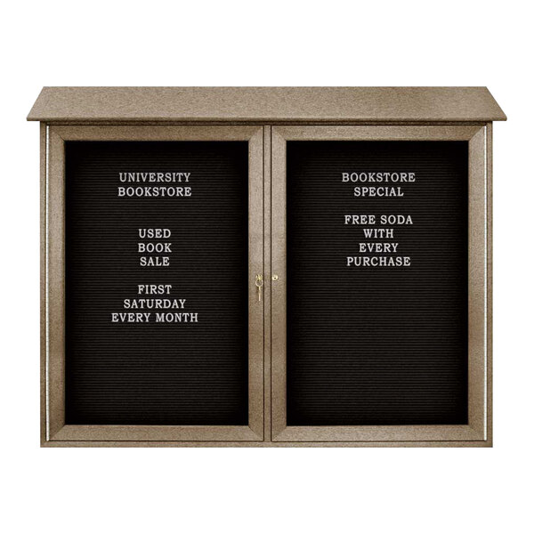 A United Visual Products double door bulletin board with black felt and white letters.