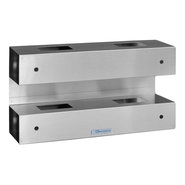 A stainless steel wall mount with 4 open boxes with holes in them.