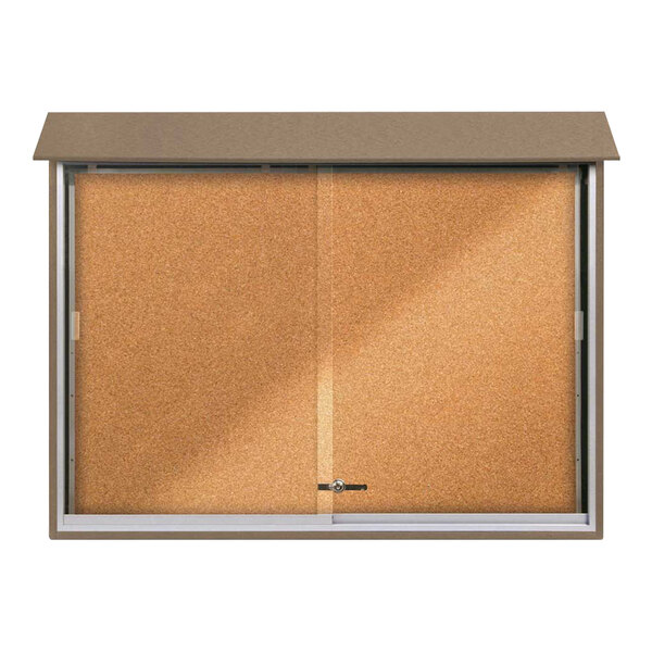 A corkboard with two sliding glass doors with a weathered wood frame.