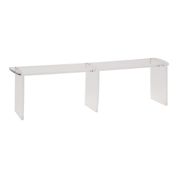 A clear acrylic table riser with two shelves.