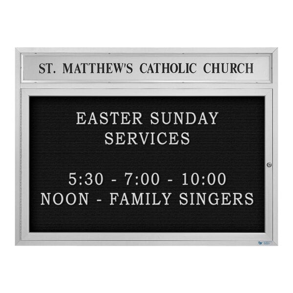 A white United Visual Products outdoor letterboard with black text that says "St. Matthew's Catholic Church"