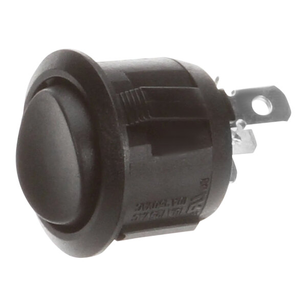 A round black button with a metal strip.