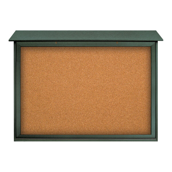 A cork board with a green frame on both sides.