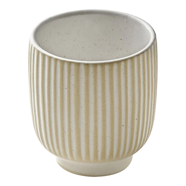 A close up of a Playground Nara white cup with a striped pattern.