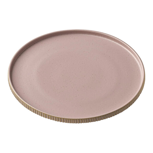 A round pink stoneware plate with a gold rim.