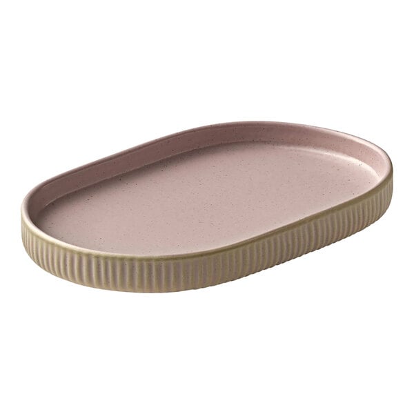 A white oval Playground Nara coupe platter with a gold rim.